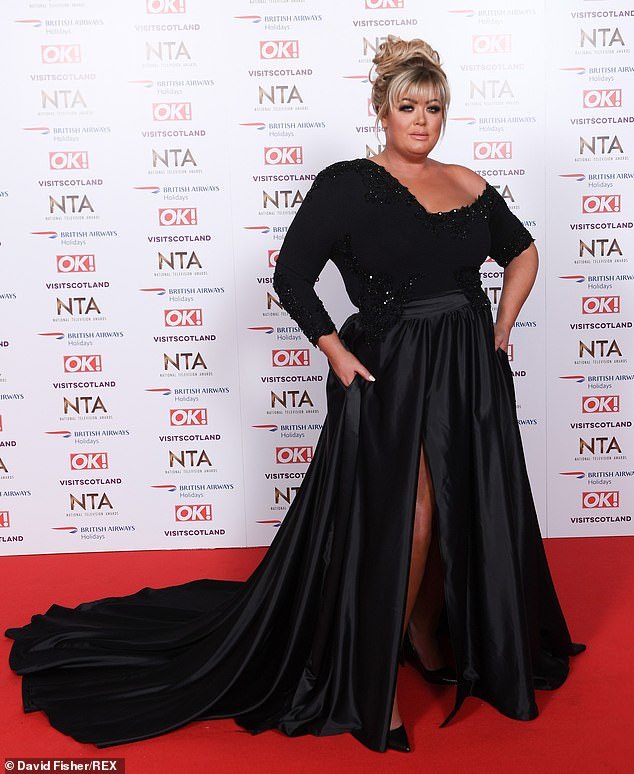 Gemma wears a satin black skirt, asymmetric black top with sequin embellishment