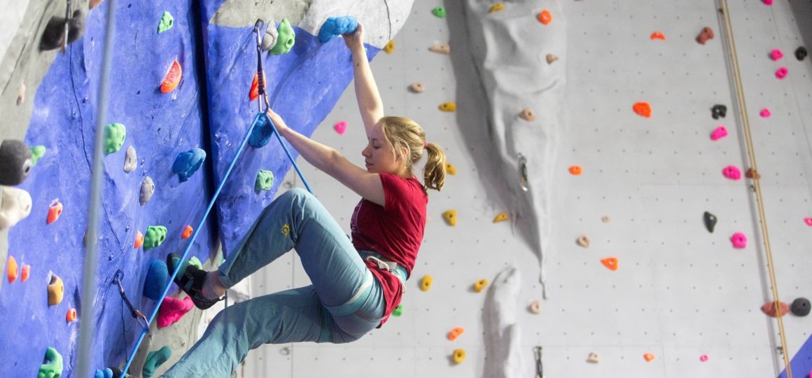 Woman climbing an indoor climbing wall